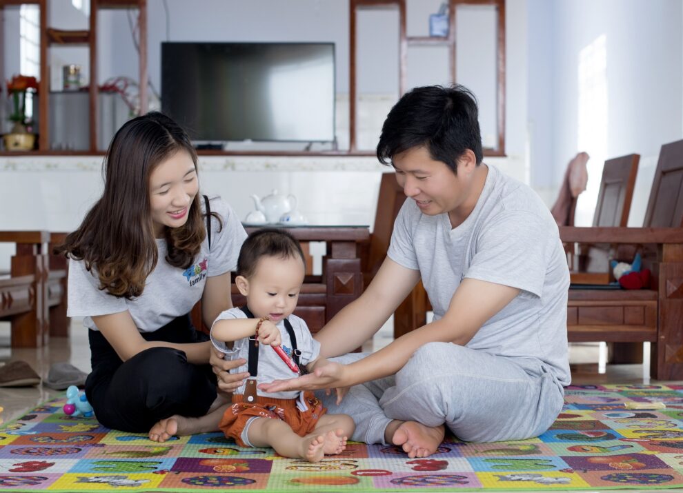 Image of a happy family discussing financial planning to safeguard their child's long-term happiness.